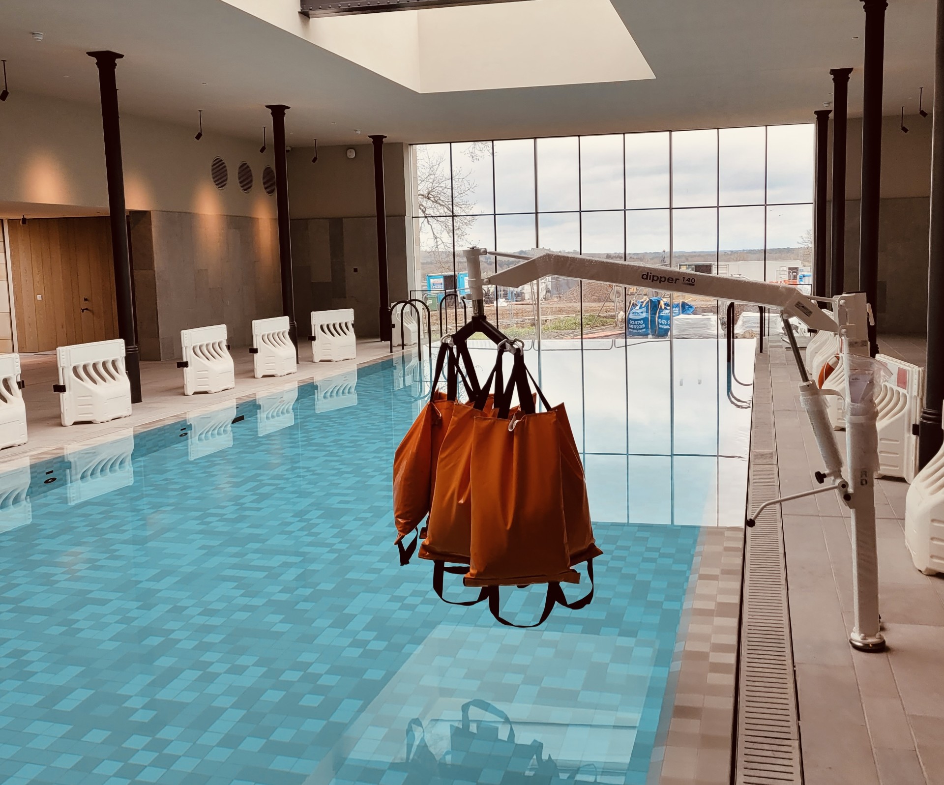 A weight test being performed on an oxford dipper hoist at a swimming pool. Part of a LOLER inspection.